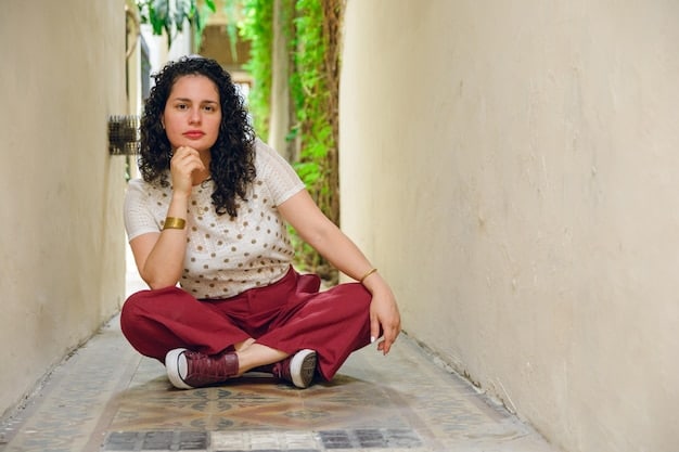 A portrait of Anya Sharma, a young woman with a thoughtful expression, sitting in a cozy library surrounded by books. Soft, warm lighting highlights the scene, emphasizing her connection to the literary world.