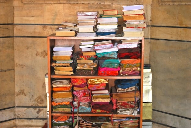 A well-organized bookshelf filled with various books, both hardcover and paperback. The books are neatly arranged, and some have bookmarks sticking out, creating a colorful and inviting display.