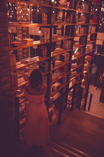 A cozy bookstore with shelves filled with books. A person is browsing through the books, looking for a new read. The lighting is warm and inviting, highlighting the spines of the books.