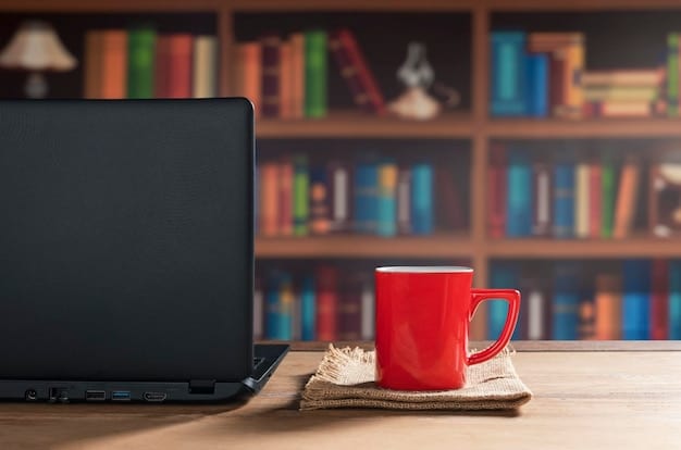 An author sitting at their desk, composing personalized emails on their laptop. There is a cup of coffee next to the laptop and books neatly stacked in the background.