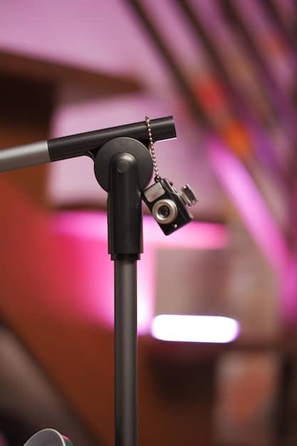 A close-up shot of a microphone on a stand, with a blurred background of an audience. The lighting is soft and focused on the microphone, symbolizing the importance of clear and engaging communication during an author Q&A session.