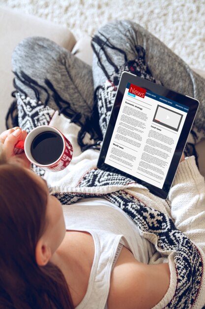 A close-up of a tablet screen displaying a book review website. The screen shows star ratings, multiple user comments, and a 