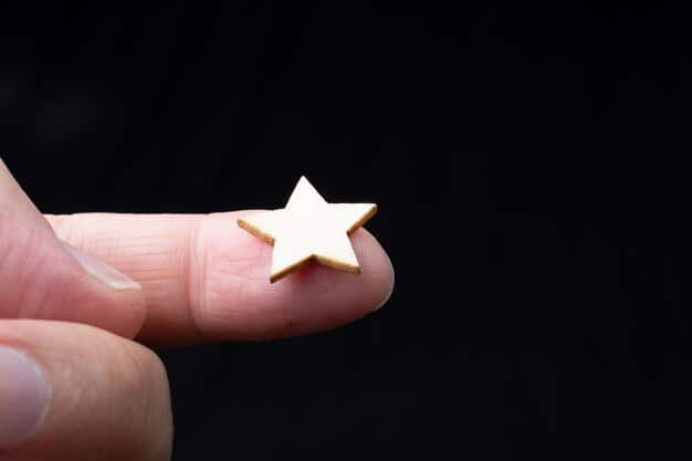 A close-up of a hand holding a book, with a faint star icon overlaid, representing the Kirkus Star review.