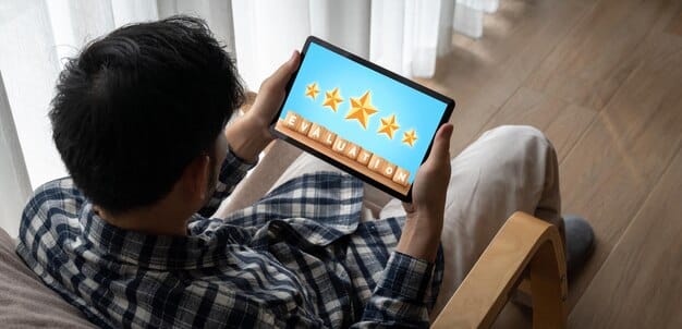A person's hand holding a tablet displaying a book review platform with various star ratings and user comments, depicting the digital interaction with reviews. The background is a cozy library setting.