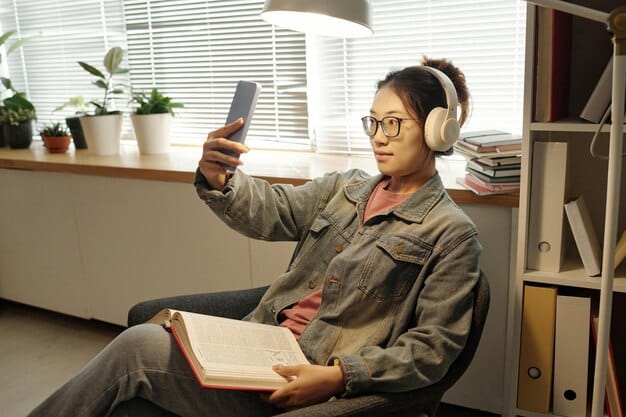A person attentively listening to a podcast on their smartphone while holding an open book in a cozy reading nook, depicting the seamless integration of audio and reading for deeper literary understanding.