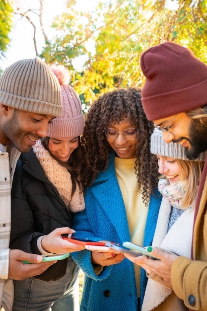 A diverse group of people, each holding a book, interacting and discussing on their phones and tablets, illustrating the concept of building an author platform and online presence through social media and digital engagement.