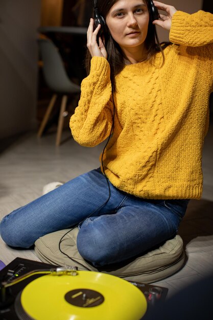 A warm, inviting scene of a person listening to a podcast on headphones, surrounded by an open book and a cozy blanket, suggesting the intimate and personal experience of audio book reviews. Soft lighting and a comfortable setting.