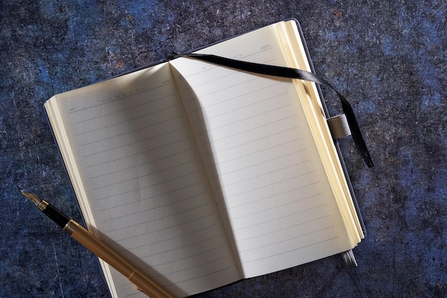 A close-up shot of an open book with handwritten notes in the margins. A pen rests on the page, suggesting active reading and annotation. The focus is on the texture of the paper and the ink of the writing, emphasizing the act of engaging with the text deeply. This visual connects to 'The Art of the Book Club Question: Crafting Prompts That Spark Deep Conversations' by illustrating thoughtful preparation.