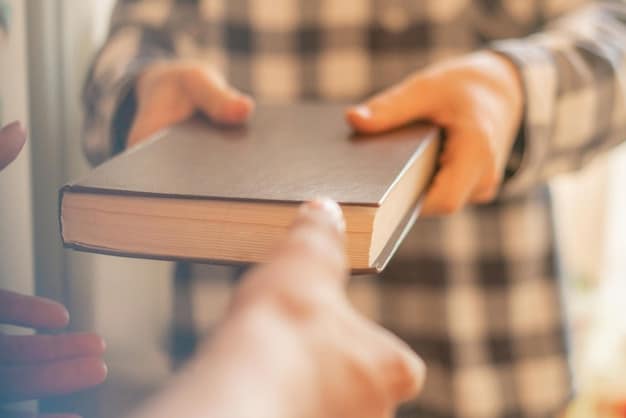 A close-up shot of hands exchanging a book between two people. The setting is a cozy living room with a bookshelf in the background. Focus on the act of giving and receiving a book during a book club book swaps: A sustainable way to refresh your reading list event.