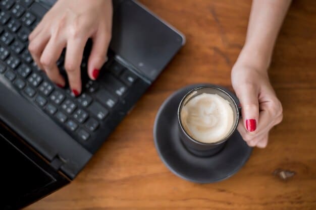 A close-up shot of a hand typing on a laptop keyboard, with a cup of coffee next to it. The screen displays a blog editor interface, highlighting the act of writing and creating content. This visual relates to the digital aspect of the Author Spotlight: From Blog to Book Deal: One Author's 18-Month Transformation.
