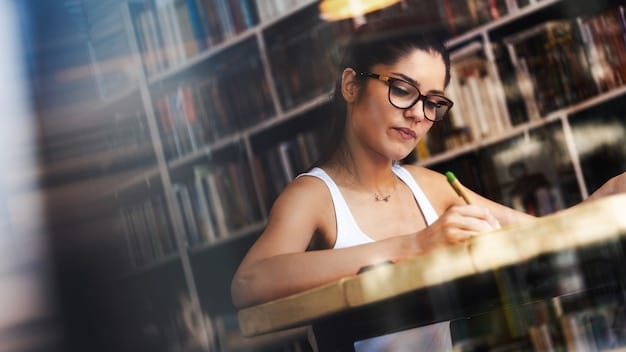 A close-up photo of a librarian shelving books in a brightly lit library. The focus is on the librarian's hands as they carefully place a copy of the book featured in 