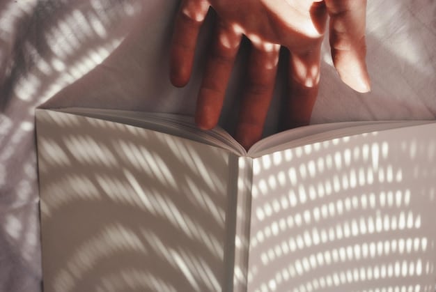 A close-up shot of a person's hands holding an open book, with sunlight streaming through a window in the background, symbolizing the joy and intimacy of reading.