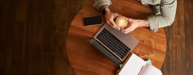 An overhead shot of a person's hands typing on a laptop, surrounded by books, a cup of coffee, and a pair of reading glasses, symbolizing the process of writing expert book reviews.