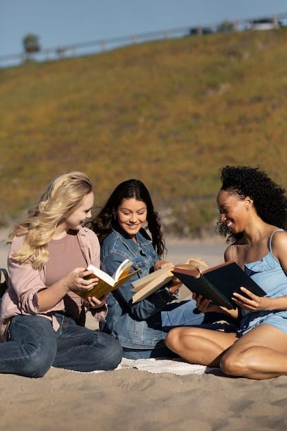 A close-up shot of a diverse group of people reading books in a sunlit park. The focus is on their expressions, showing concentration and engagement.