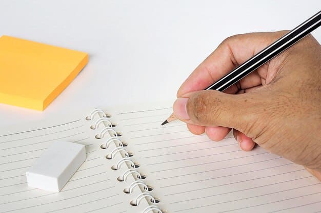 A close-up shot of a critic's hands writing in a notebook with a pen. The notebook is open to a page with scribbled notes and annotations. A stack of books can be seen blurred in the background. The scene suggests careful analysis and note-taking, capturing the essence of 'The Art of the Book Review: A Guide for Aspiring Critics in the US'.