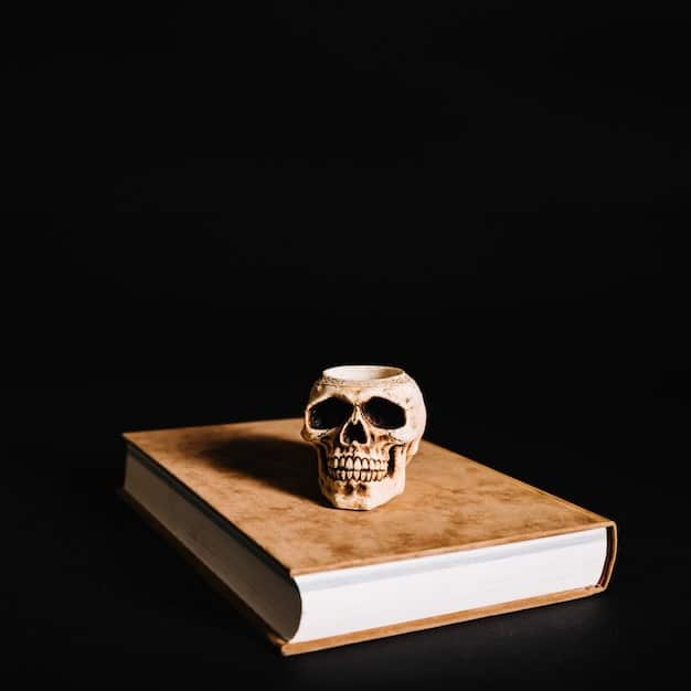 A close-up of a vintage book with a skull on the cover, highlighting the existential themes in Dark Academia.